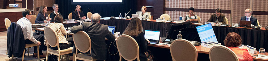 Members of the PCORI Board of Governors seated around a conference room table during a 2019 meeting.