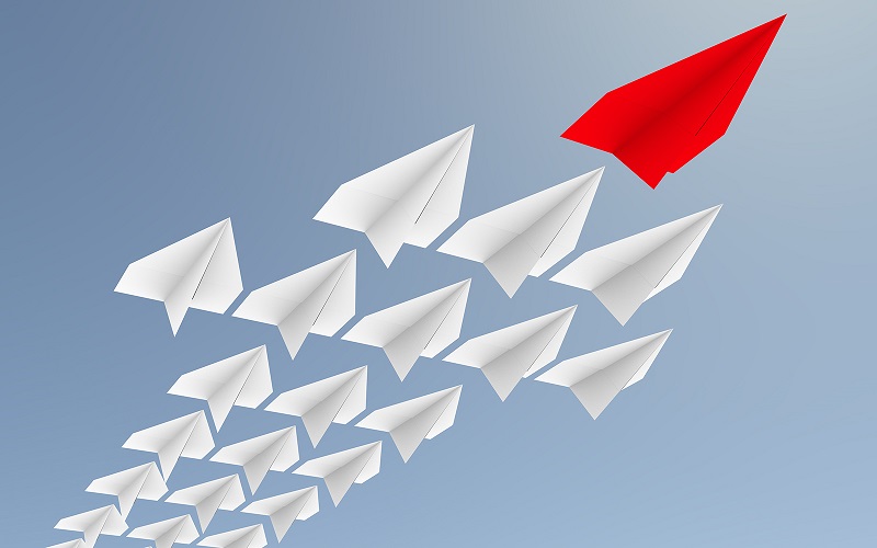 Image of paper planes flying in one direction